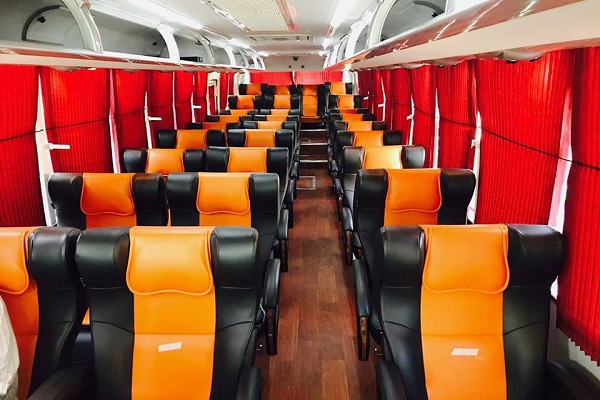 Inside a real Faisal Movers coach — reclining 2+2 seats with curtains